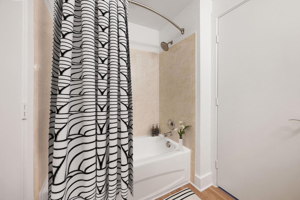 a bathroom with a shower curtain and a bath tub