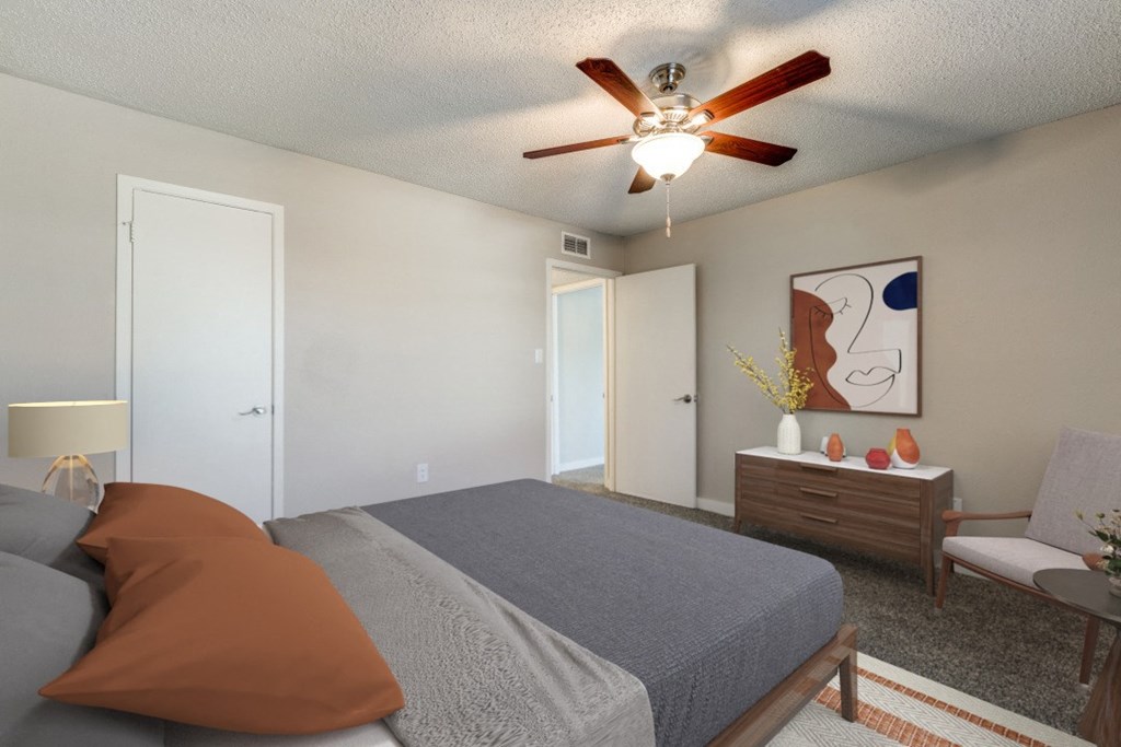 a bedroom with a large bed and a ceiling fan