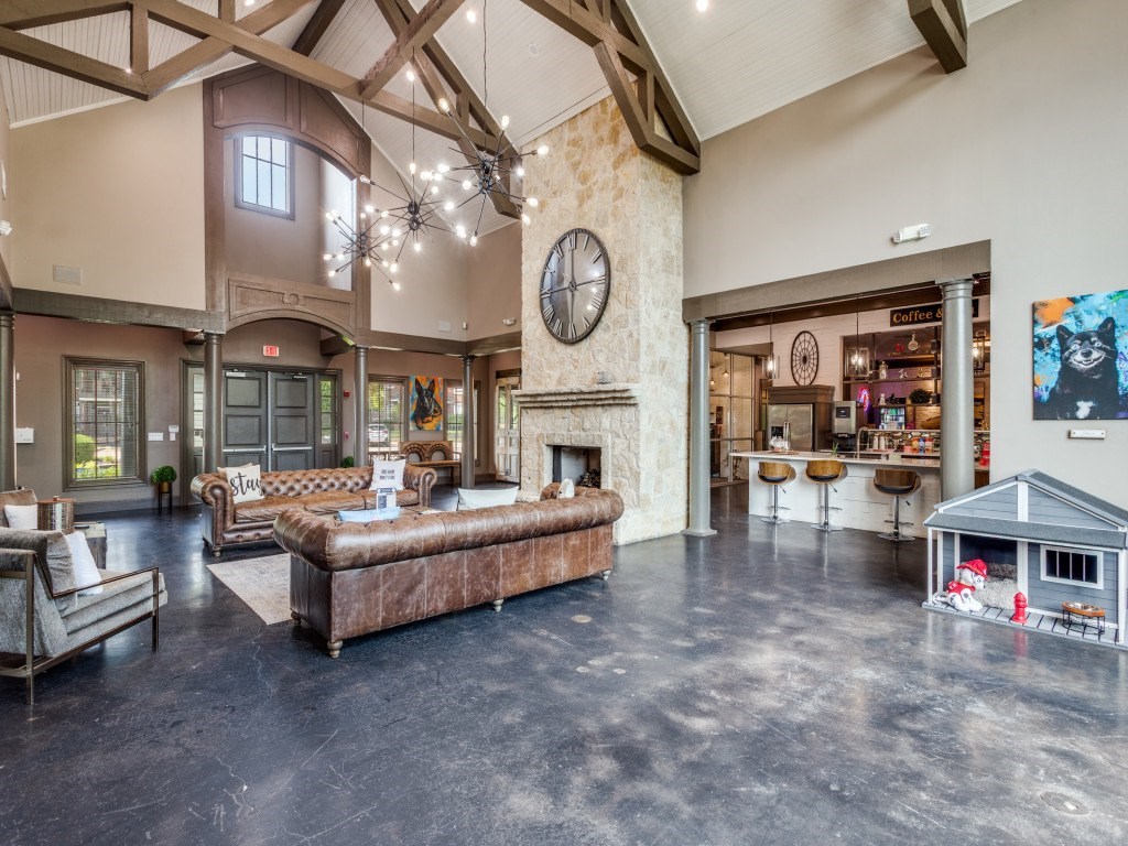 A large, open-concept living space with a fireplace and a variety of seating options.