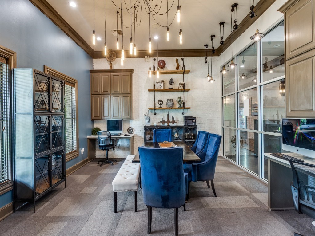 A modern dining room with a large table and chairs.