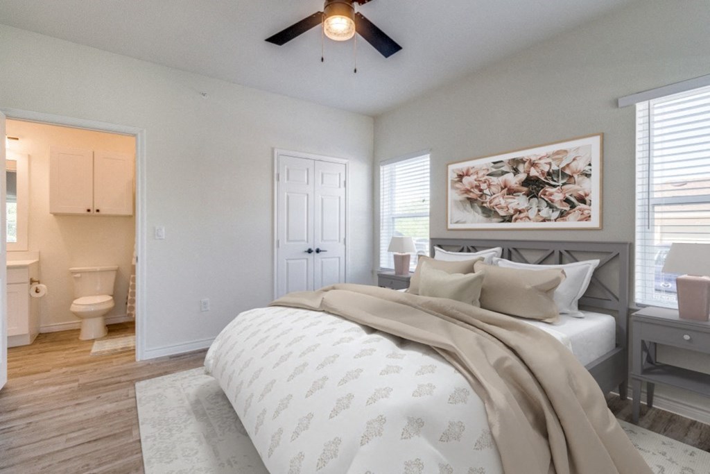 a bedroom with a bed and a ceiling fan
