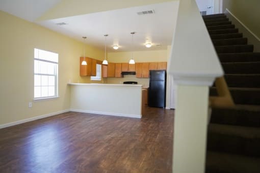 A room with wooden floors and a staircase.