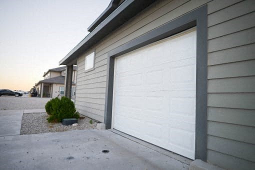 A white garage door is closed.