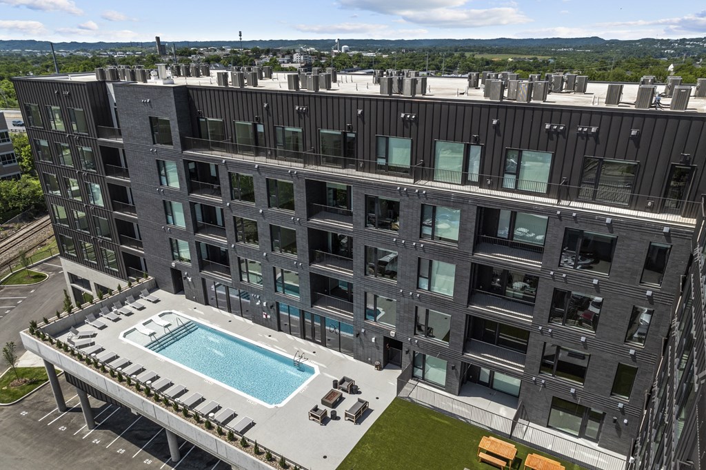 an aerial view of a building with a swimming pool