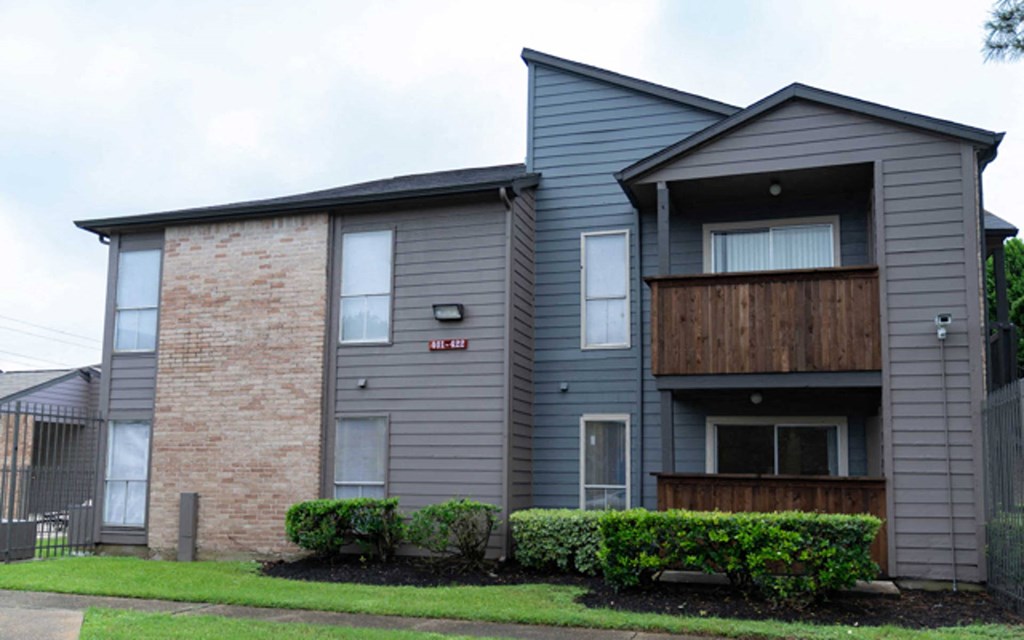 an apartment building and brick and a wooden balcony