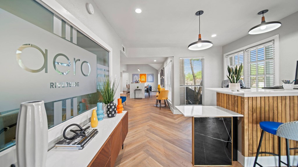 a kitchen and living room with a counter and a window