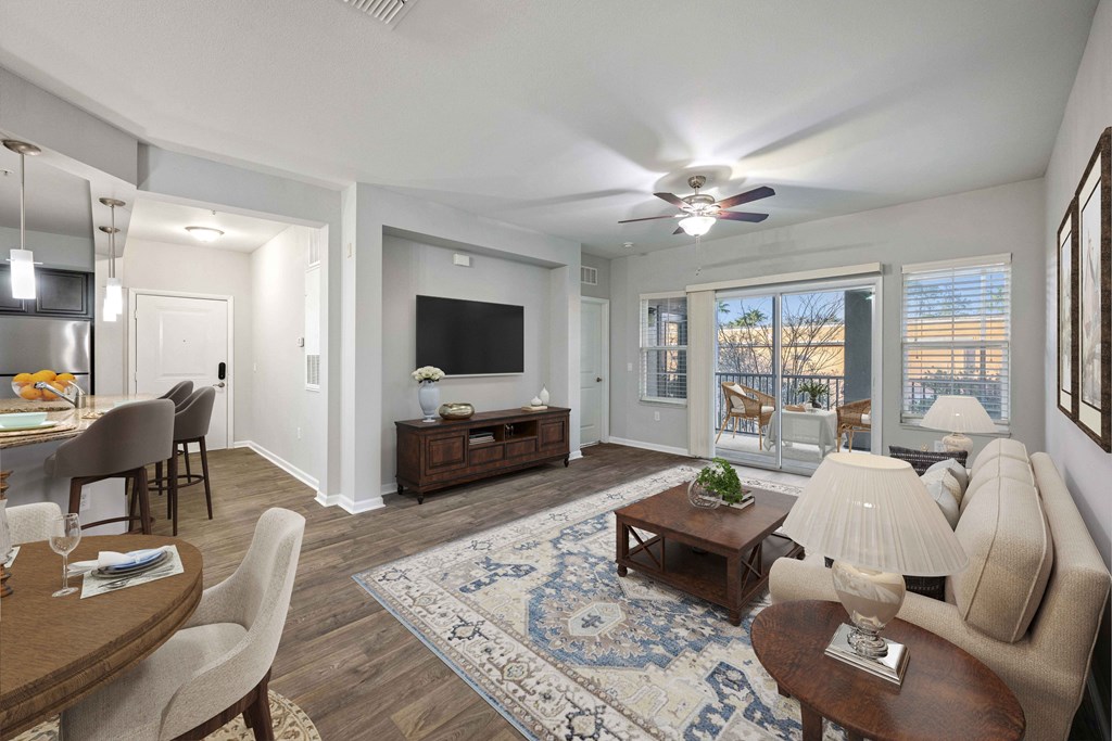 a living room with a ceiling fan and a television