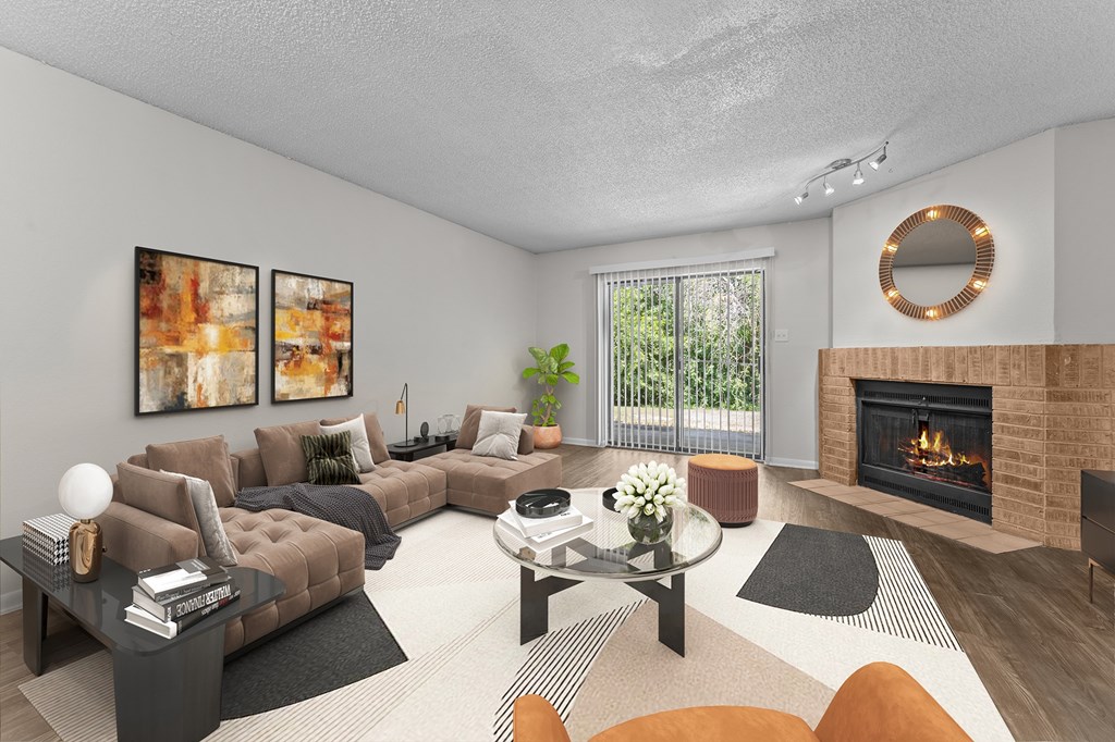 A modern living room with a fireplace and a glass coffee table.