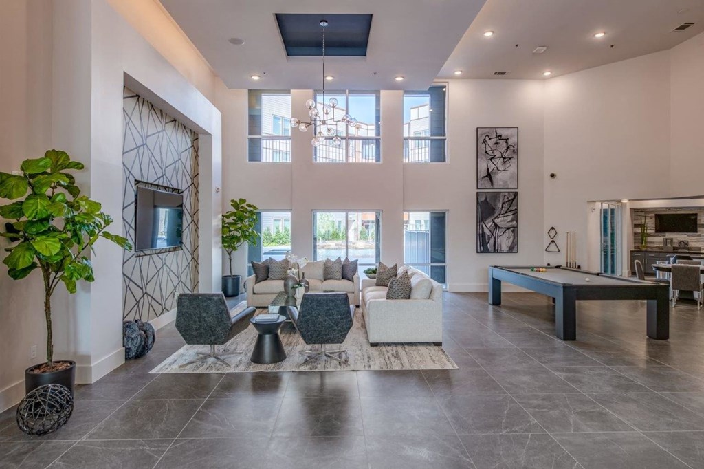 a large living room with a ping pong table and a billiards table