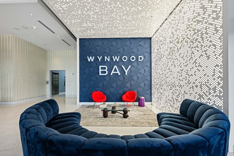 a living room with blue couches and a wall with a www wood