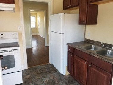 kitchen fridge with brown cabinets