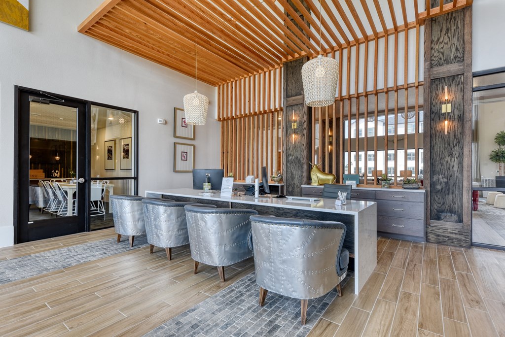 a large dining room with a marble table and chairs
