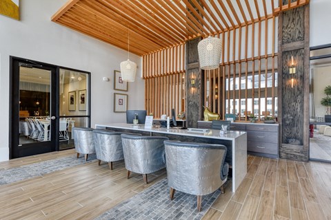 a large dining room with a marble table and chairs