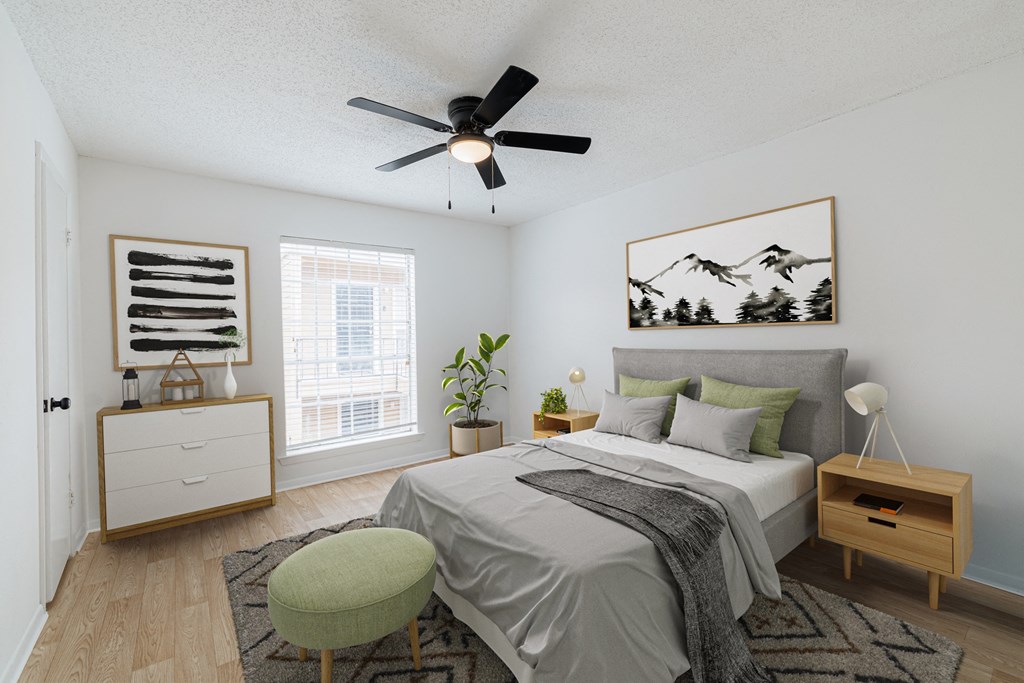 a bedroom with a large bed and a ceiling fan