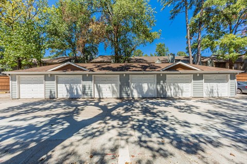 A house with a brown roof and a white garage door.