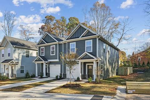 A grey house with a white door and windows.