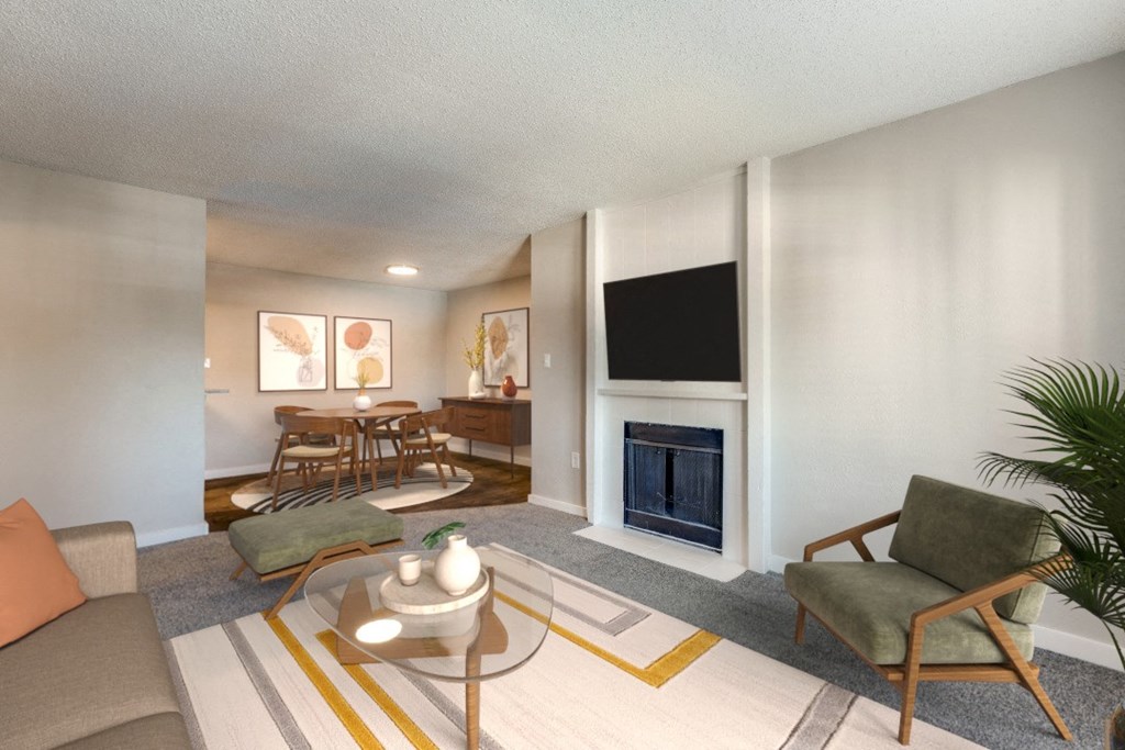 a living room with a fireplace and a table and chairs