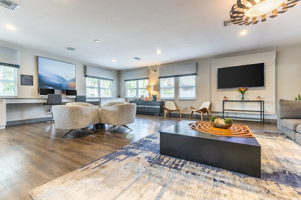 A modern living room with a large flat screen TV mounted on the wall.