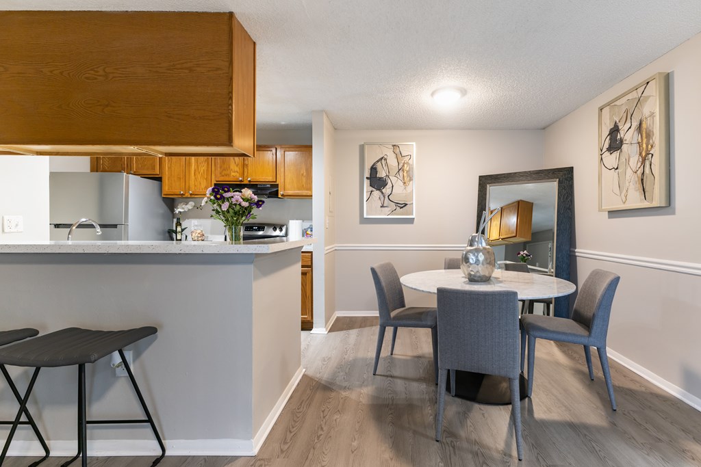 A kitchen with a table and chairs in the foreground.