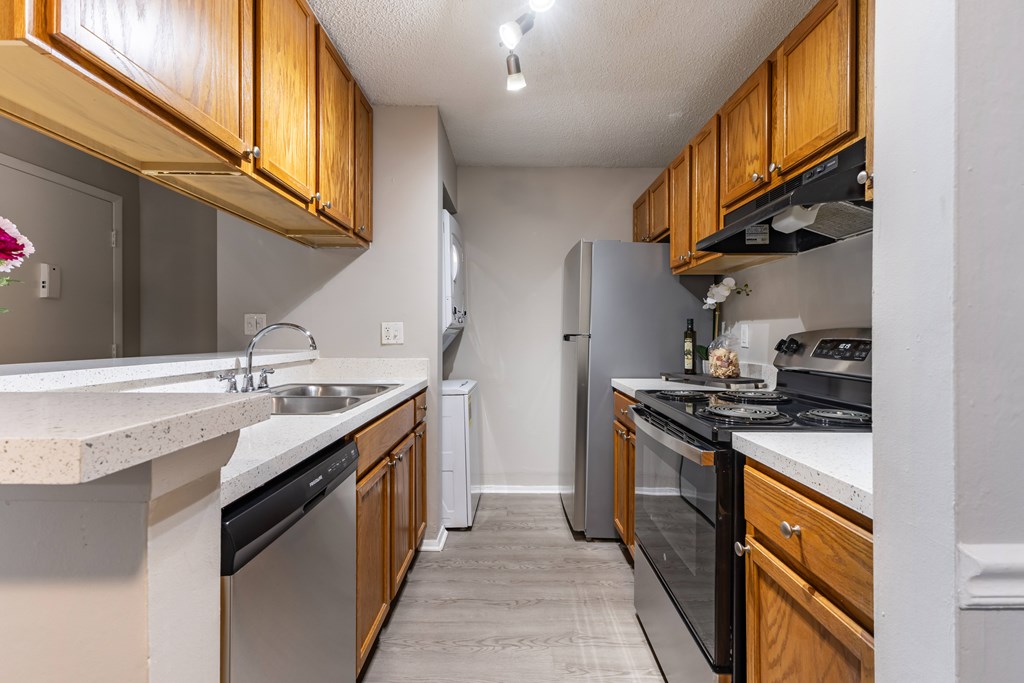 A kitchen with wooden cabinets and stainless steel appliances.
