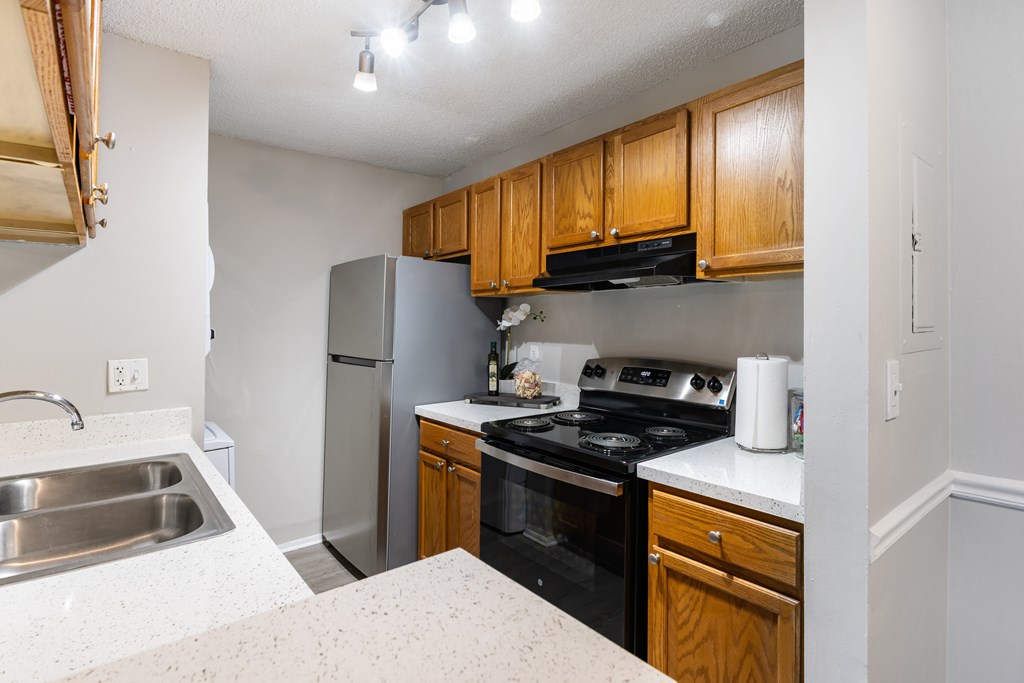 A kitchen with wooden cabinets and stainless steel appliances.