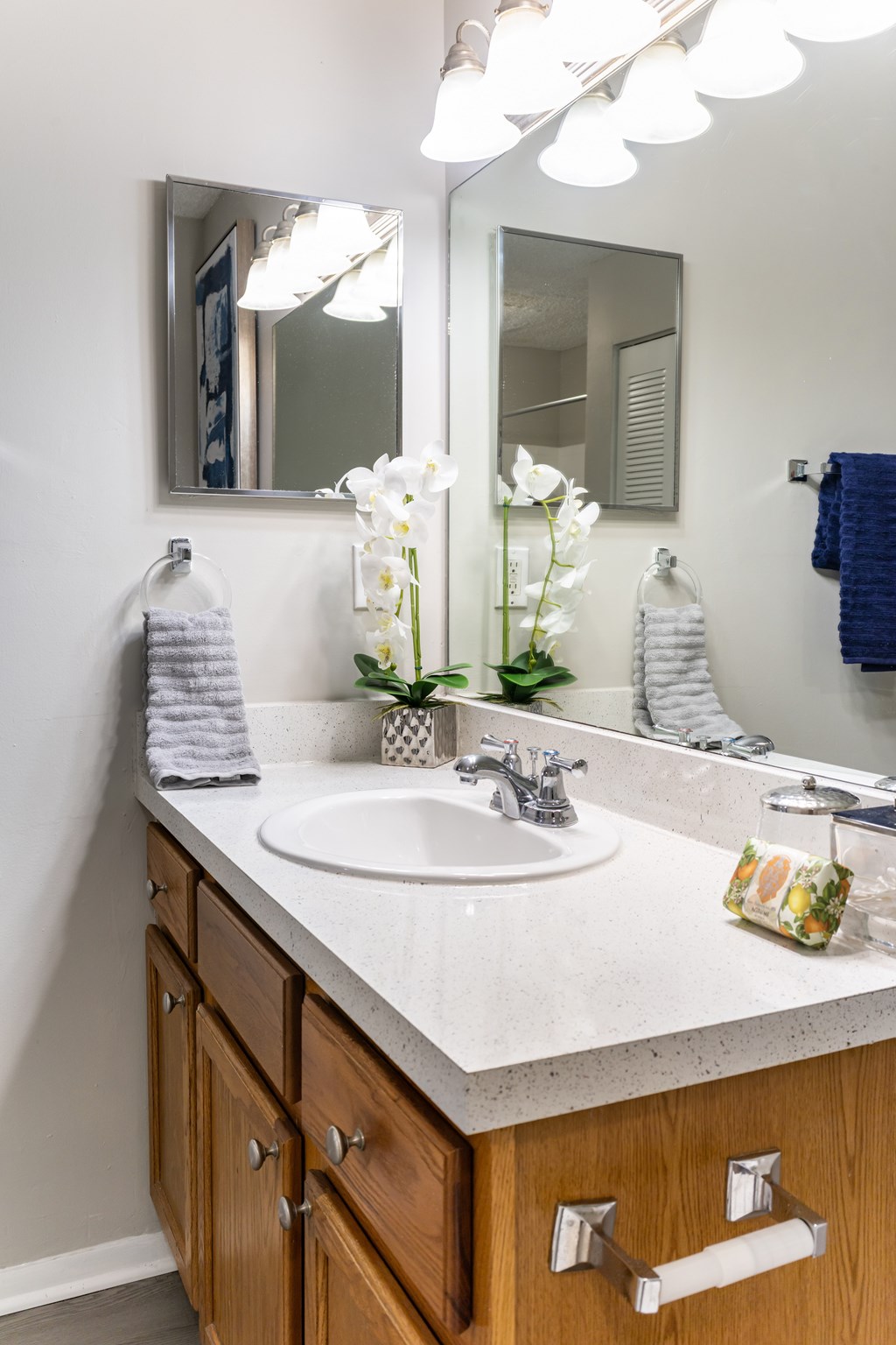 A bathroom with a white sink and a mirror above it.