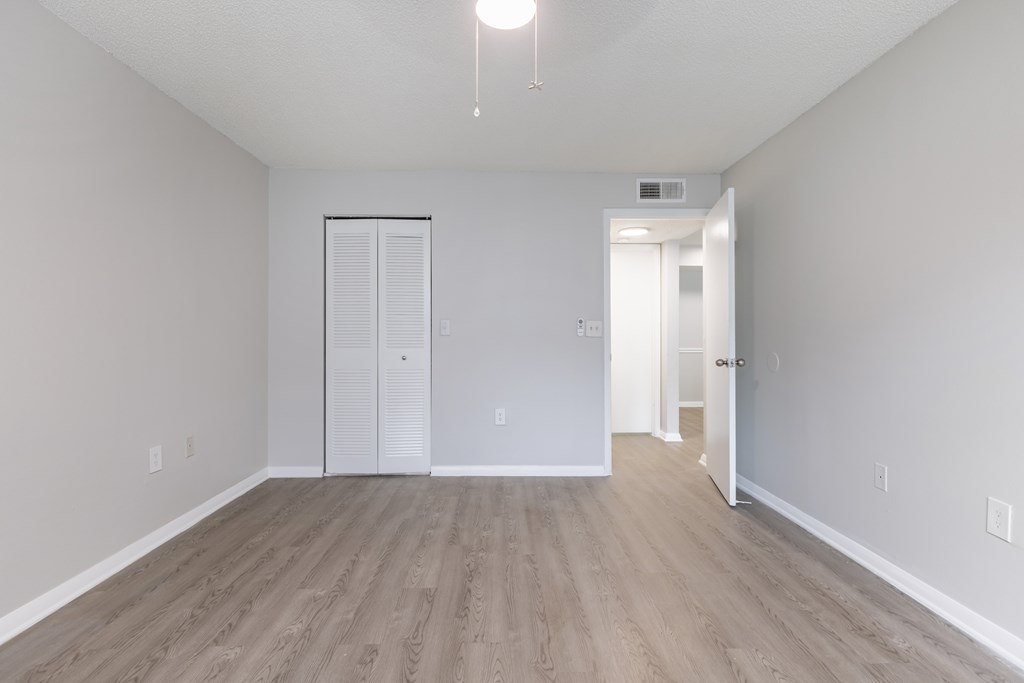 A room with a white door and a white wall.