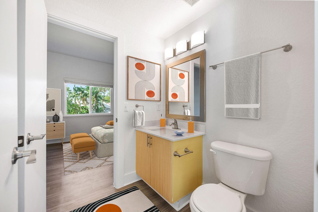 a bathroom with a toilet and a sink and a mirror