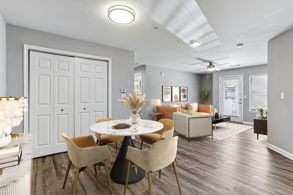 an open living room and dining room with a table and chairs