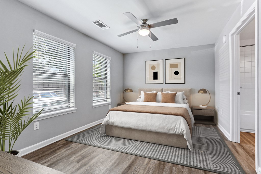 a bedroom with a bed and a ceiling fan