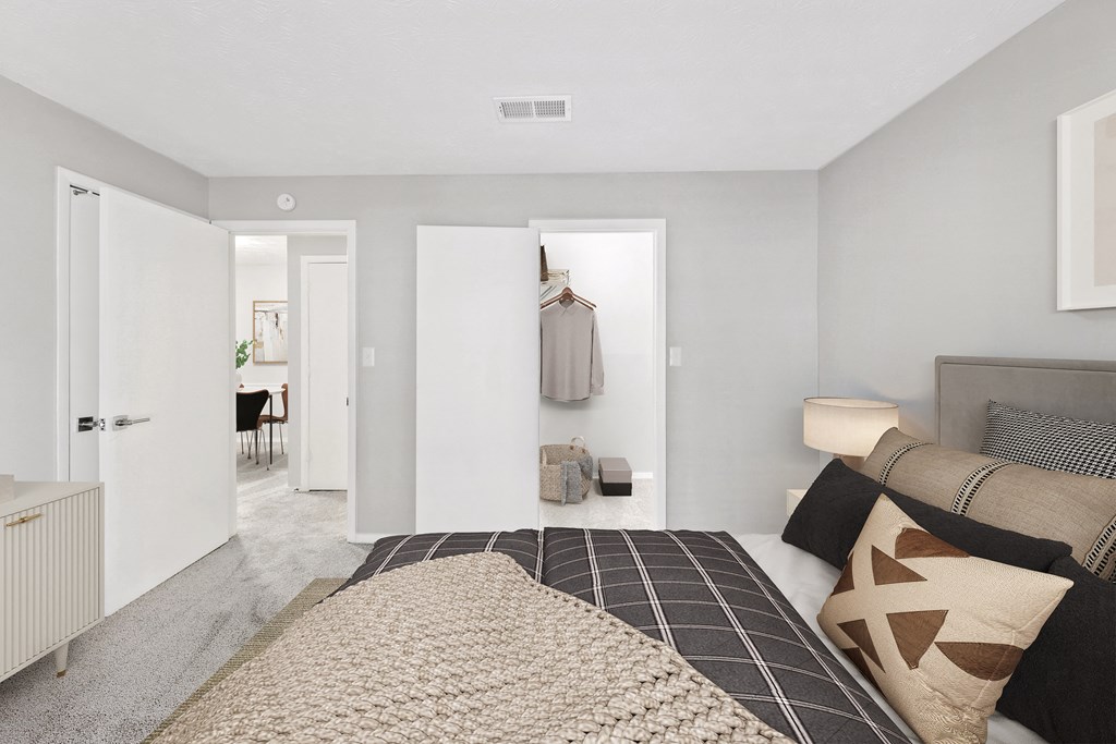 a bedroom with a bed and a closet