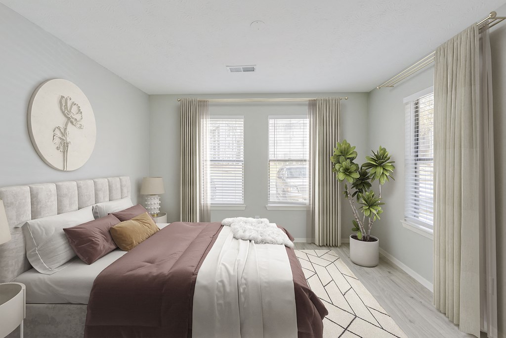 a bedroom with a bed and two windows