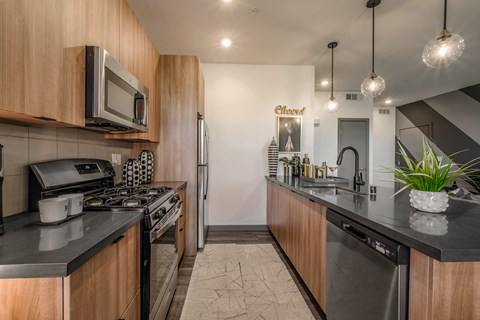a kitchen with stainless steel appliances and black counter tops