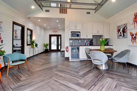 A modern kitchen with a wooden floor and a dining table with chairs.