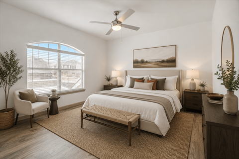 A bedroom with a large bed, a chair, and a painting on the wall.
