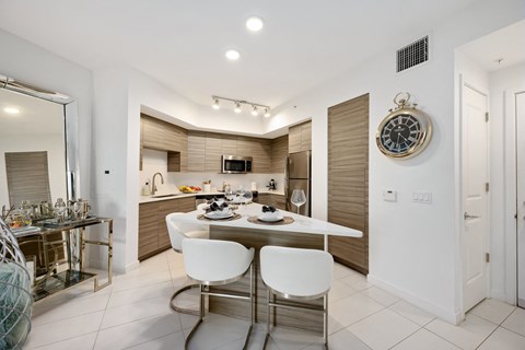 a kitchen and dining area with a table and chairs