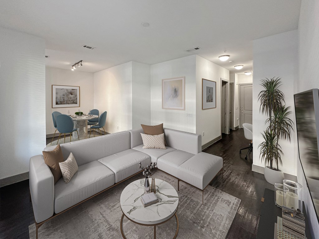 a living room with a white couch and a glass coffee table