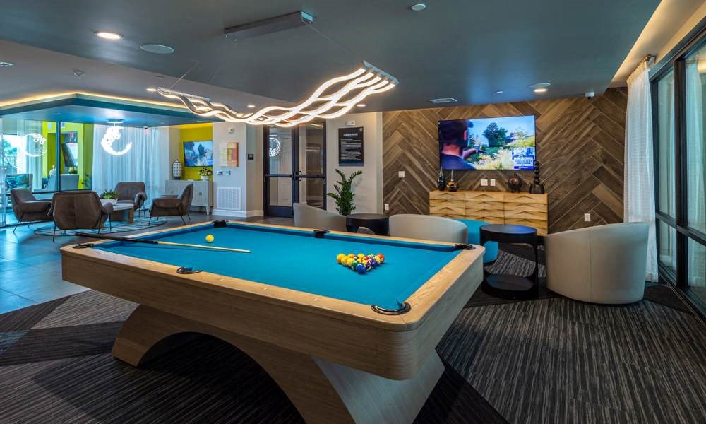 a pool table in a room with a tv