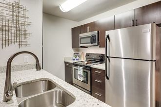 our spacious kitchen has stainless steel appliances and granite counter tops