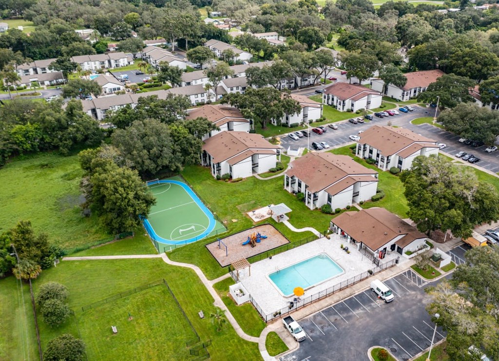 an aerial view of a neighborhood with houses and a swimming pool