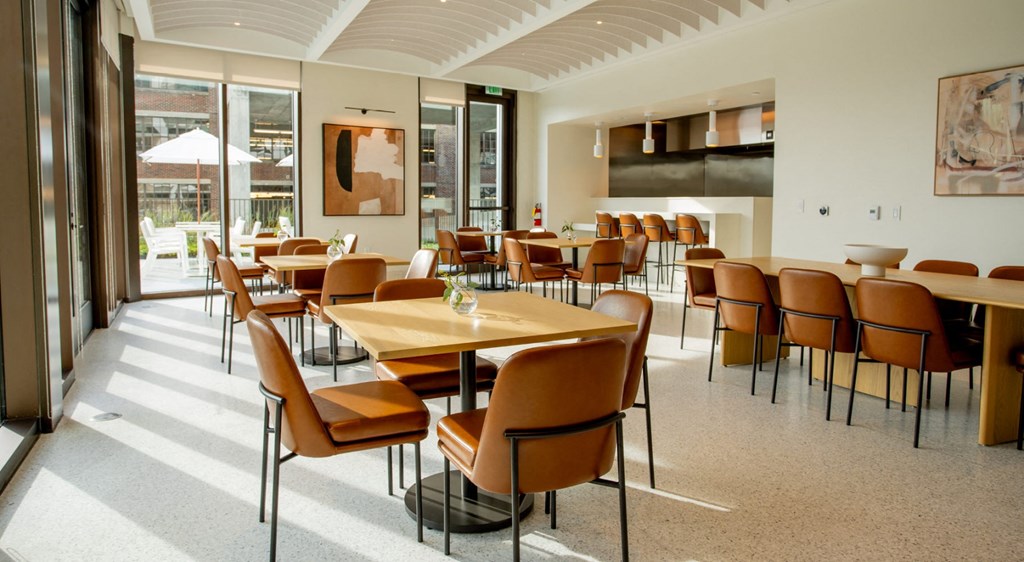A large dining room with a long table and chairs.