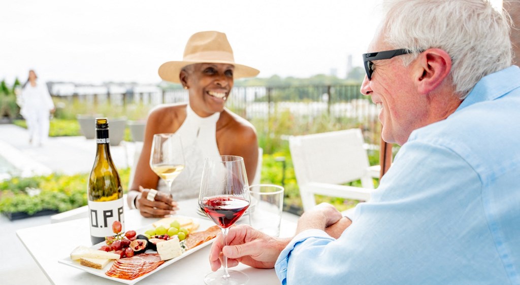 A man and a woman are having a meal together outdoors.