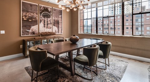 A dining room with a table and chairs and a chandelier.
