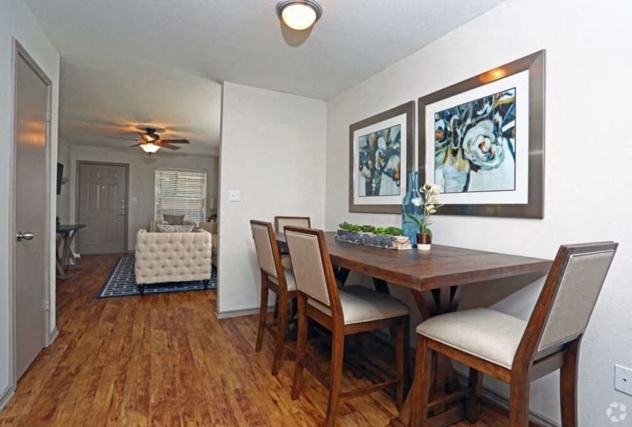 a dining room with a table and chairs and a living room