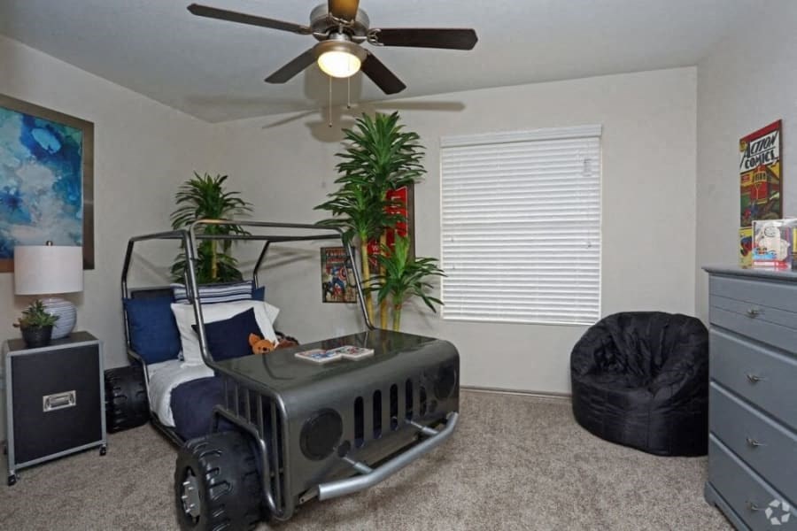 a bedroom with a bed and a ceiling fan