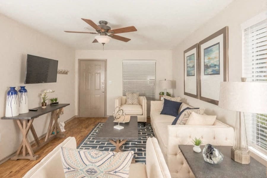 a living room with a couch and a ceiling fan