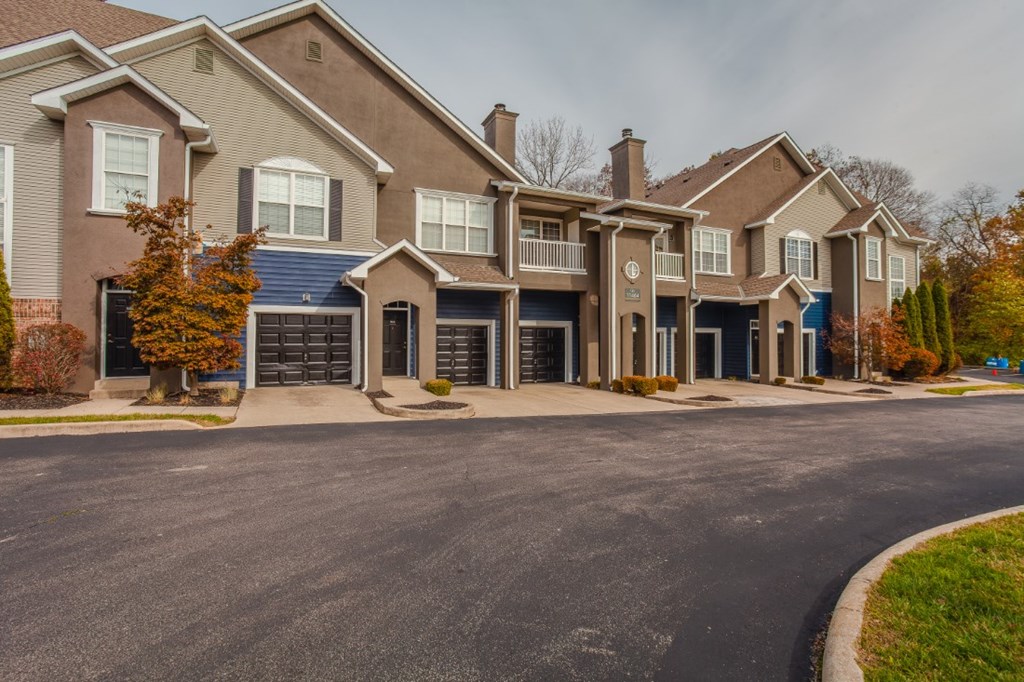 A row of houses with a driveway in front.