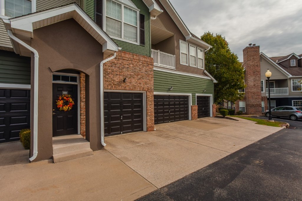 A house with a garage and a wreath on the door.
