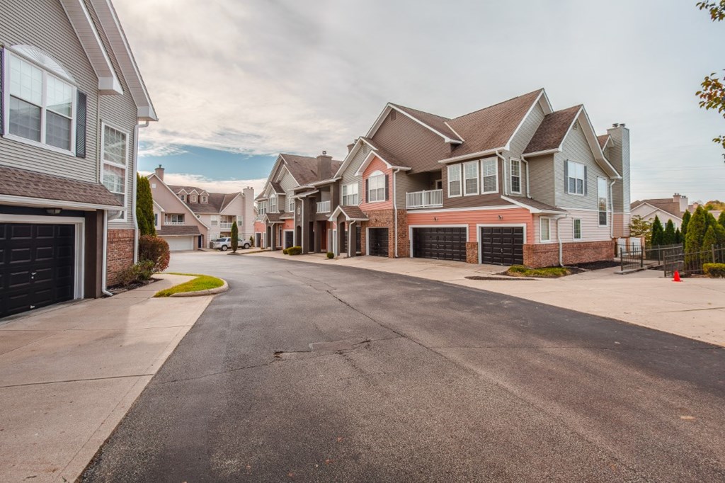 A street view of a residential area with houses on both sides.