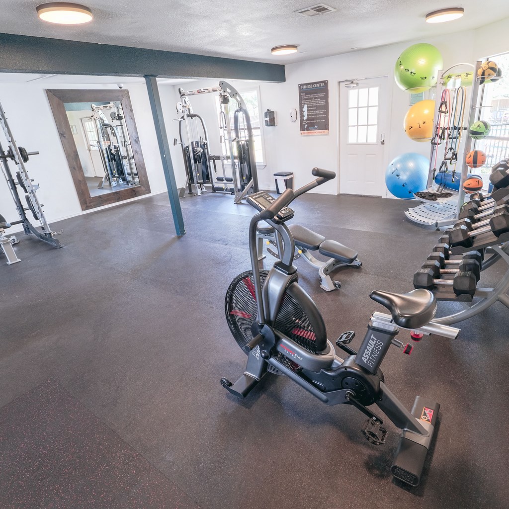 A gym with a stationary bike in the foreground.